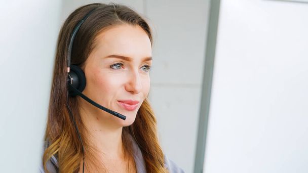 Business people wearing headset working in office to support remote customer or colleague. Call center, telemarketing, customer support agent provide service on telephone video conference call. - Fotoğraf, Görsel