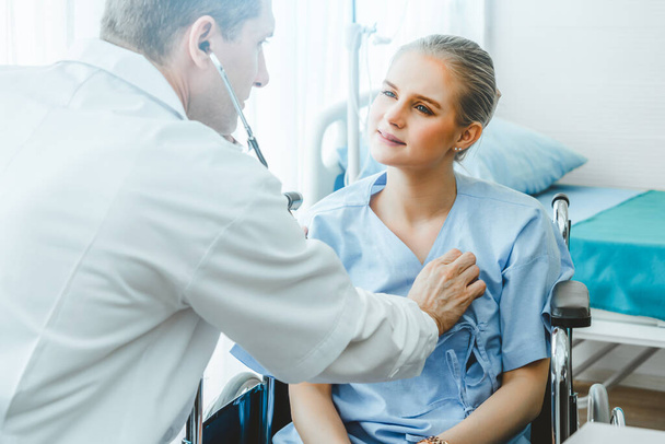 Doctor in professional uniform examining patient at hospital or medical clinic. Health care , medical and doctor staff service concept. - Photo, Image