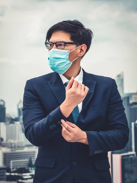Young office worker with face mask quarantine from coronavirus or COVID-19. Concept of protective working environment to reopen business and stop spreading of coronavirus or COVID-19. - Photo, image