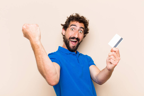 young cool bearded man with a credit card. success concept - Foto, imagen