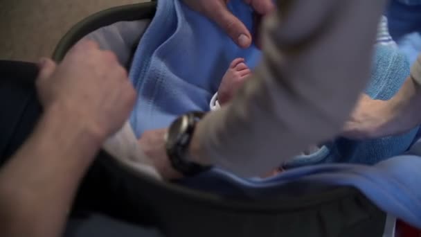 Parents are fitting clothes on their baby - Footage, Video