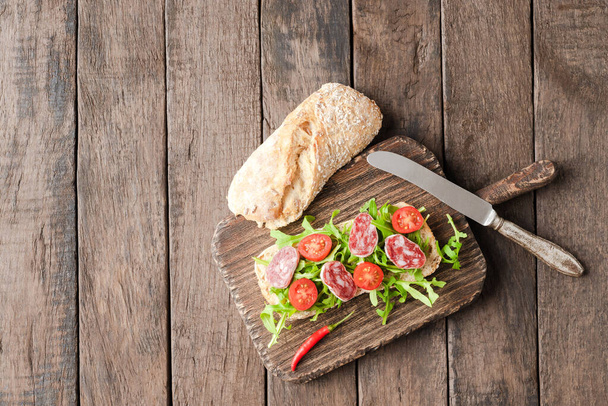 Delicious homemade sandwich on wooden board - Photo, Image