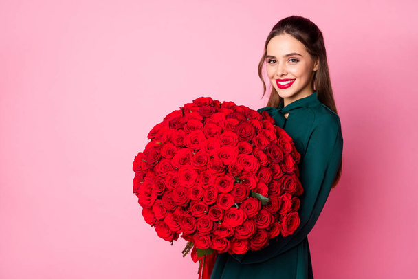 Photo of attractive charming fancy lady red lips hold large roses bouquet boyfriend birthday compliment wear green dress isolated pastel pink color background - Фото, зображення