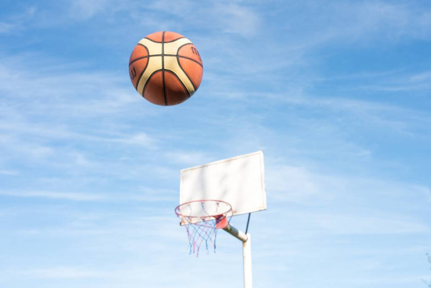 A basketball ball in the air near the basket - Foto, Imagen