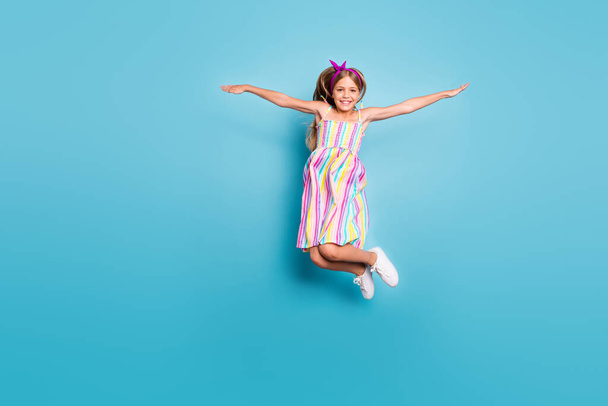 Full length body size view of her she nice-looking attractive lovely free cheerful cheery girl jumping having fun vacation holiday isolated over bright vivid shine vibrant blue color background - Valokuva, kuva