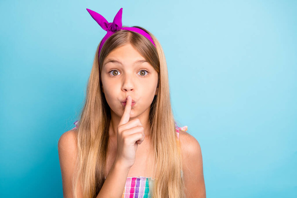 Hush dont tell anyone. Amazed girl kid hear incredible information put finger lips mouth ask stop share rumor wear style stylish trendy dress skirt isolated over blue color background - Foto, afbeelding