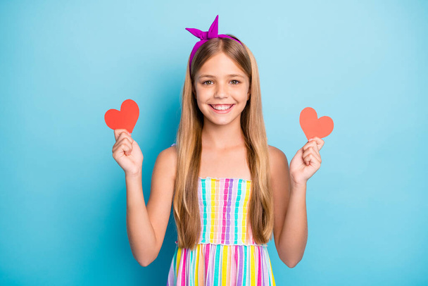 Portrait of her she nice attractive charming pretty cheerful long-haired girl holding in hands two small heart figure form amour cupid isolated on bright vivid shine vibrant blue color background - Photo, Image