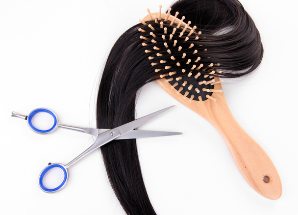 Long black hair with hairbrush and scissors isolated on white - Foto, immagini