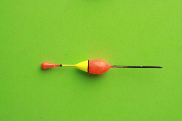 A closeup shot of the fishing lure isolated on a green background - Photo, Image