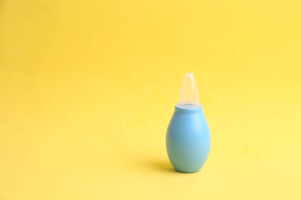A nasal aspirator with soft tip isolated on yellow  background - Φωτογραφία, εικόνα