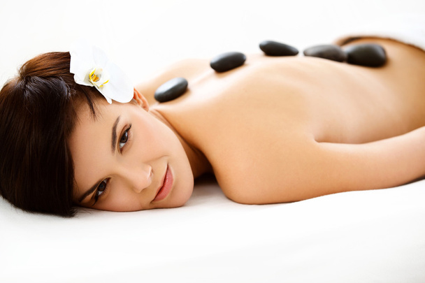 Spa Woman. Beautiful Woman Getting Hot Stones Massage in Spa Salon - Zdjęcie, obraz