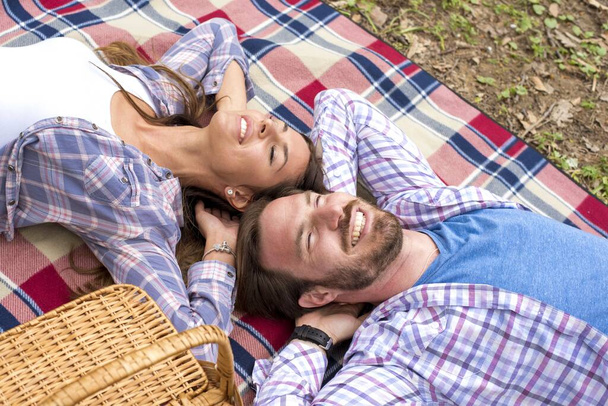 A closeup shot of a young couple having picnic in a park - Photo, image