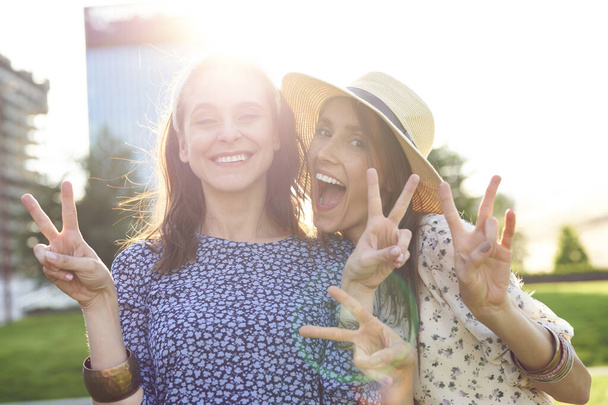 Δύο γελαστές όμορφες γυναίκες στο φως του ήλιου                                - Φωτογραφία, εικόνα