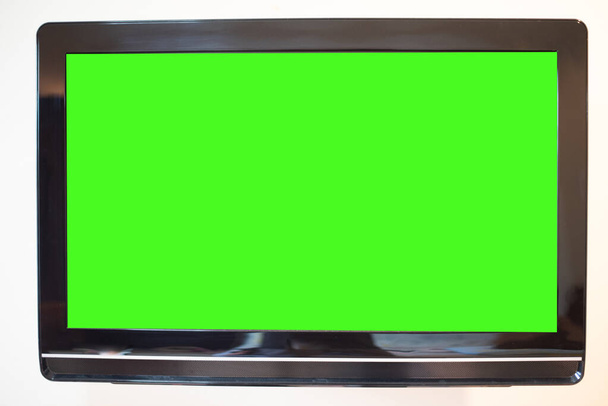 Close up monitor groen scherm op muur achtergrond. - Foto, afbeelding