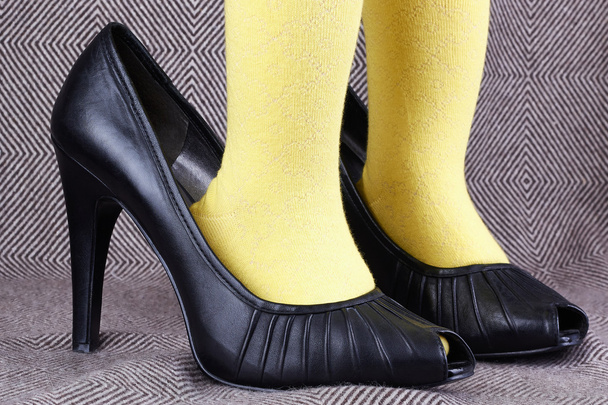 Una niña en zapatos de tacón alto de mujer
 - Foto, Imagen
