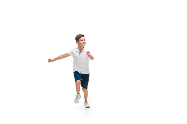 Happy little caucasian boy jumping and running isolated on white background - Foto, Imagen