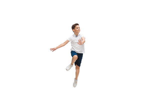 Happy little caucasian boy jumping and running isolated on white background - Foto, imagen