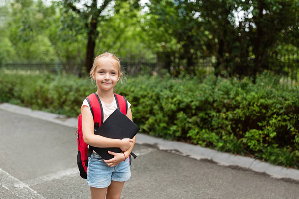 School child after end coronavirus pandemic outbreak. Blonde girl going back to school after covid-19 quarantine and lockdown. Happy kid outdoor. New normal. High quality photo - Φωτογραφία, εικόνα