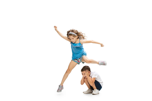 Happy little caucasian girl and boy jumping and running isolated on white background - Foto, Imagem