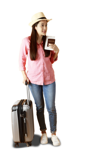 Aasian naiset pitkät hiukset kuluvat Olkihattu musta nauha kädessä tilalla passin kirja ja matkakassi. Nainen valmis matkustamaan matkalaukku ja passi keltaisella pohjalla. Kesämatkailun käsite. - Valokuva, kuva