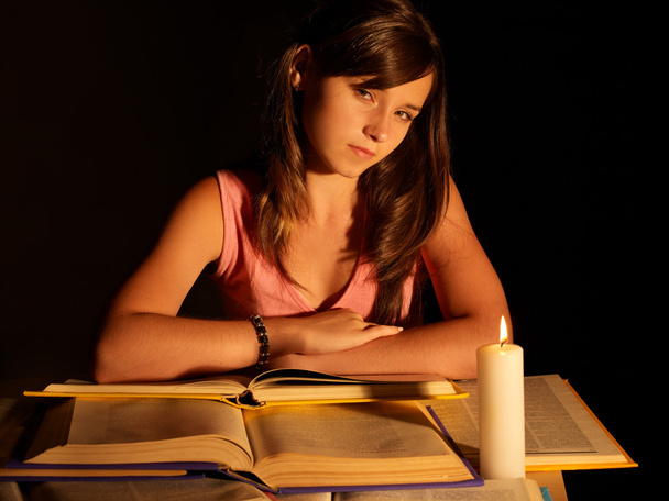 Girl reading book with candle. - Photo, Image