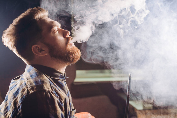 magicical smoking. young man relaxing with hookah - 写真・画像
