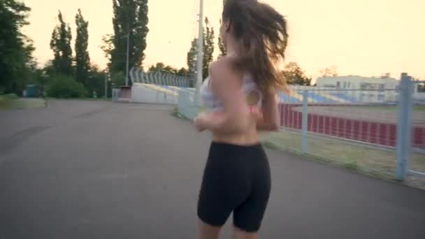 Fit woman jogging exercising running for cardio loads - Кадри, відео