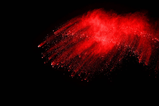 abstract red powder explosion on black background.abstract red powder splatted on black background. Freeze motion of red powder exploding. - Foto, Imagen