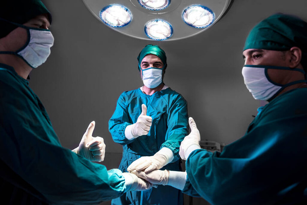 Group Surgeon doctor consent after Patient surgery in hospital operating theater .   Teamwork medical doctor working  performing surgery - Φωτογραφία, εικόνα
