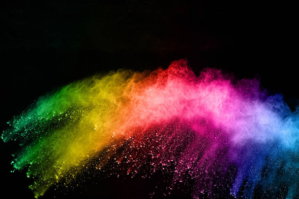 abstract colored dust explosion on a black background.abstract powder splatted background,Freeze motion of color powder exploding/throwing color powder, multicolored glitter texture. - Foto, Imagem