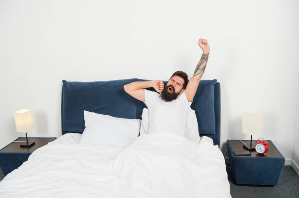 Sleepy early morning. Bearded with sleepy look in morning. Sleepy hipster stretch and yawn in bed. Wokeup sleepy. Awakening. Bedtime routine. Nap time. Feeling as though he got no sleep at all - Foto, imagen
