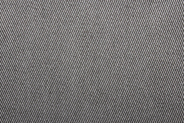 Grey denim background.The texture of denim grey fabric is fluted in light stripes. - Фото, зображення