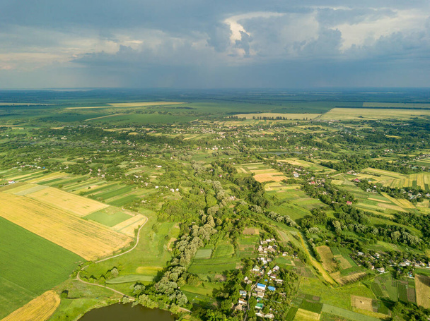 Αεροφωτογραφία τηλεκατευθυνόμενου. Αγροτικά πεδία κοντά σε ένα χωριό στην Ουκρανία. - Φωτογραφία, εικόνα