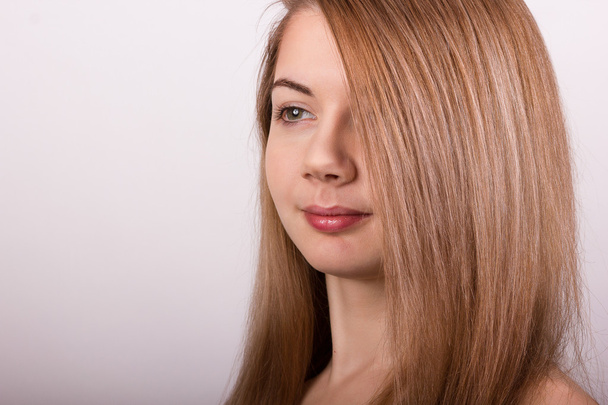 Studio portrait of a beautiful young woman with blond long hair without makeup - Fotografie, Obrázek