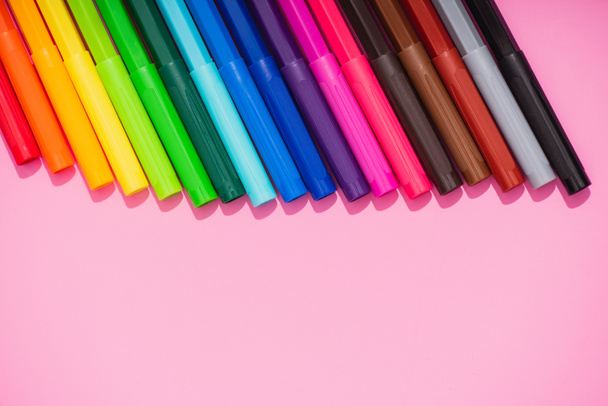 top view of color felt-tip pens set on pink background with copy space - Foto, Imagem