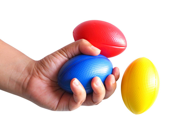 mano e palle di stress colorate giallo, rosso, blu, spremere palla per l'esercizio della mano. isolato su sfondo bianco. - Foto, immagini