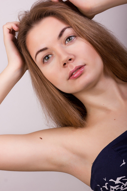 Studio portrait of a beautiful young woman with blond long hair without makeup - Foto, afbeelding