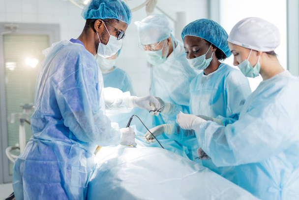 skilled and registered doctors doing medical procedure - Foto, Imagem