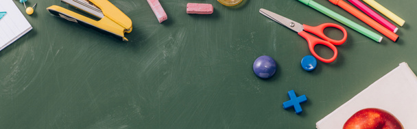 top view of school stationery on green chalkboard, panoramic crop - Photo, Image