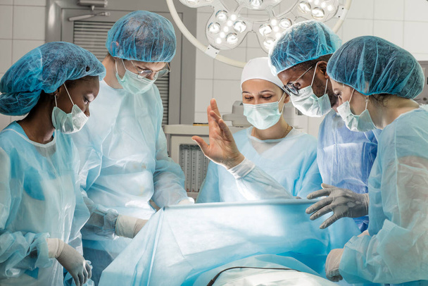 patient raising his arm while sleeping during the operation - Valokuva, kuva
