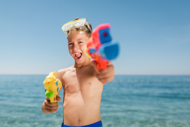 Adorable boys playing with water guns on hot summer day. - Photo, Image