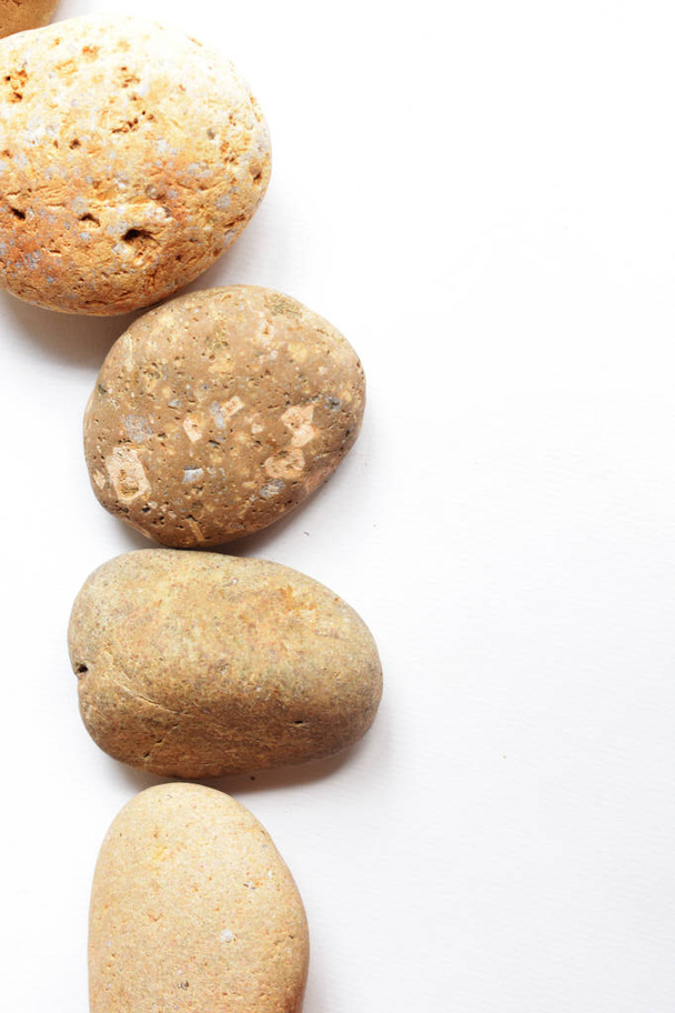 Abstract rocks pebbles frame in white background, flat lay, top view, spa, peace, relax, meditation, ancient concept, memory, vintage, geography, discovery, traditional, hobo style, bohemian - Foto, Imagen