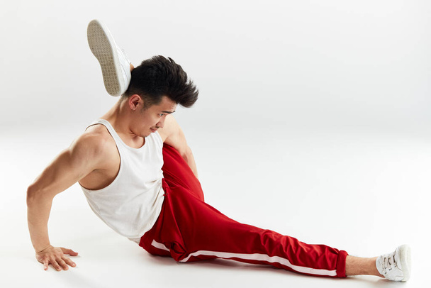 Asian man gymnastic warming up isolated studio on white background - 写真・画像