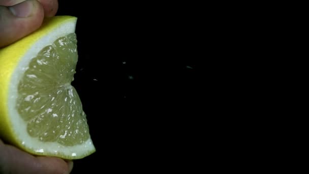 Squezzing segment of a lemon to get the juice - Footage, Video