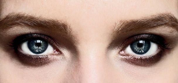 Evening makeup Smokey eyes. Beautiful blue eyes of a girl close-up. Design of a beauty banner. - Fotoğraf, Görsel