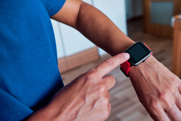 woman arm using smartwatch to control activity indoor - Photo, Image