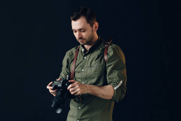 Photographer turning on his digital camera - Фото, зображення