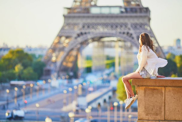 Beautiful young woman in Paris near the Eiffel tower at morning. Parisian girl on Trocadero view point. Tourist enjoying vacation in France - Foto, Bild