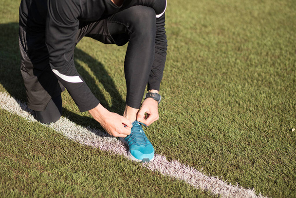 female in sportswear tying his shoelaces - Photo, Image