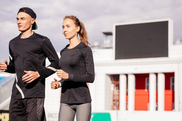Activity, energy, health concept. couple is fond of jogging - Foto, afbeelding
